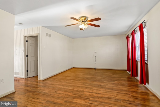 unfurnished room with dark hardwood / wood-style flooring and ceiling fan