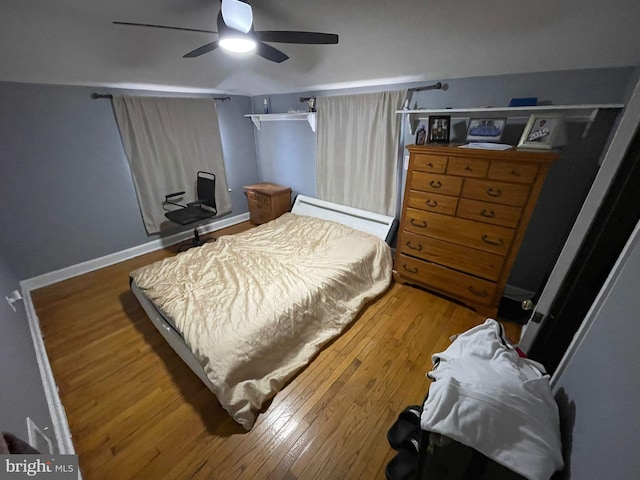 bedroom with hardwood / wood-style floors and ceiling fan