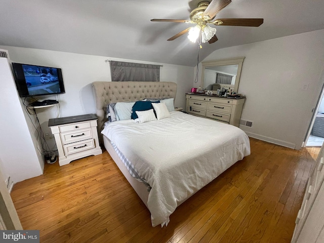 bedroom with lofted ceiling, hardwood / wood-style floors, and ceiling fan