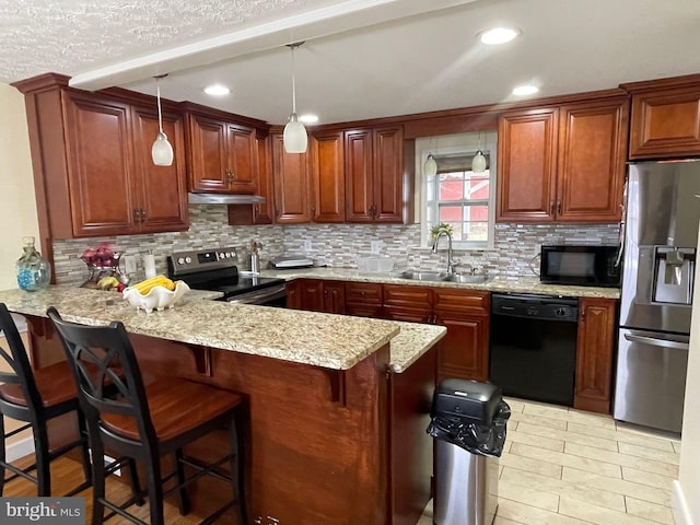 kitchen with a breakfast bar, sink, hanging light fixtures, kitchen peninsula, and black appliances