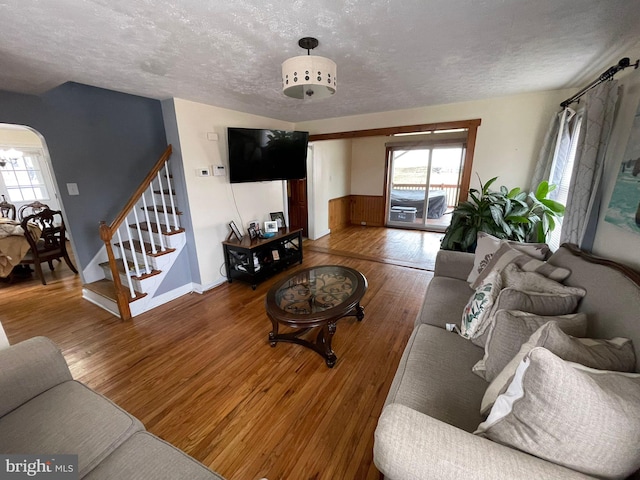 living room with wood-type flooring and a textured ceiling