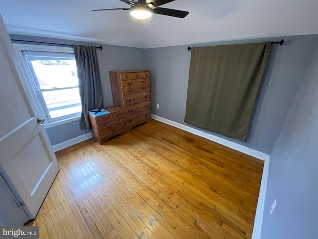 unfurnished bedroom with ceiling fan and light hardwood / wood-style floors