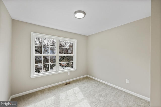 empty room featuring light colored carpet