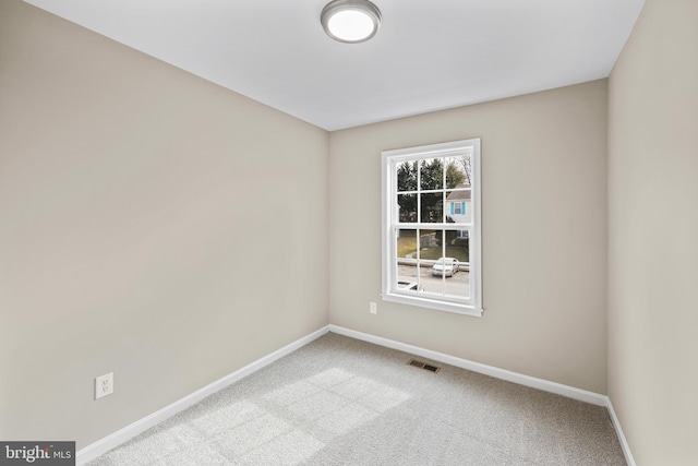 unfurnished room featuring light colored carpet