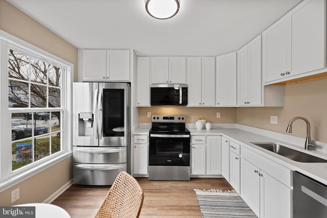 kitchen featuring sink, white cabinets, and stainless steel appliances