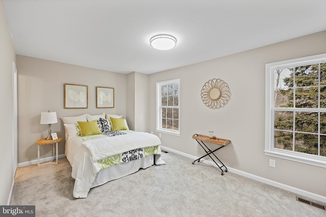 bedroom featuring light colored carpet