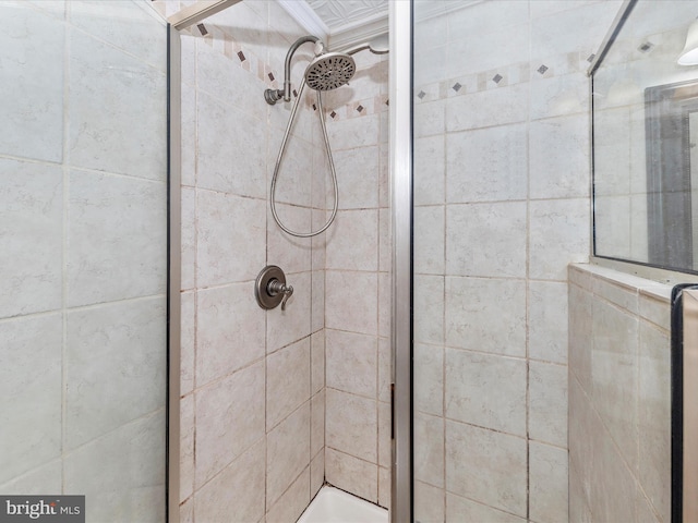 bathroom with a shower with door