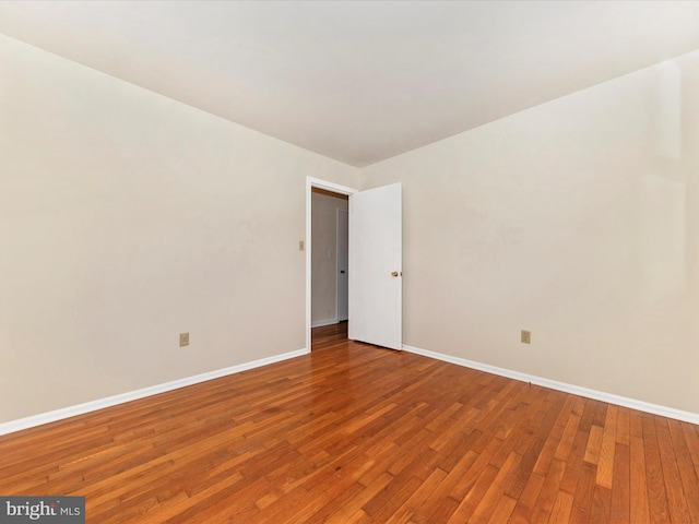 unfurnished room featuring hardwood / wood-style flooring