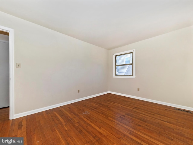 empty room with hardwood / wood-style flooring