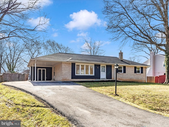 single story home with a front lawn and a carport