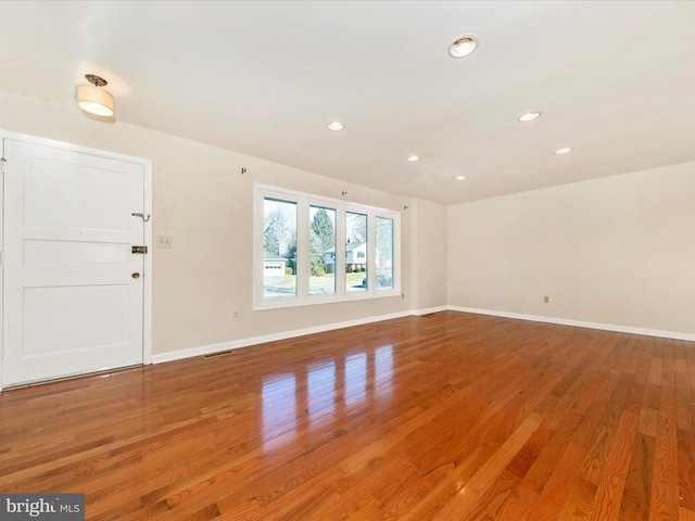 unfurnished living room with wood-type flooring