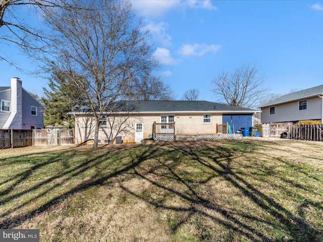 back of property featuring a lawn