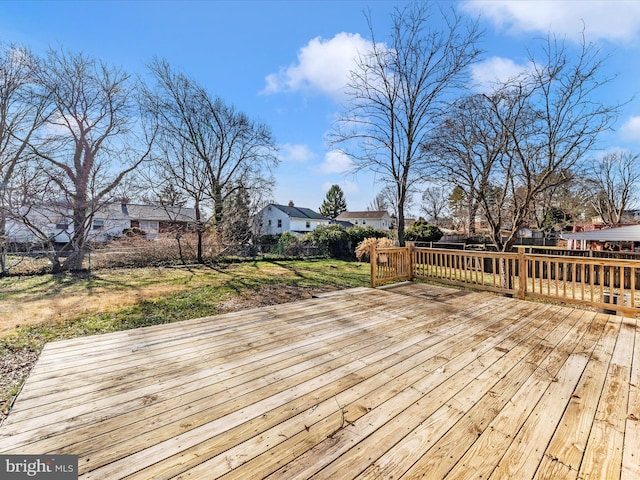 wooden deck featuring a yard