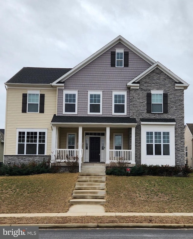 view of front of home with covered porch and stone siding