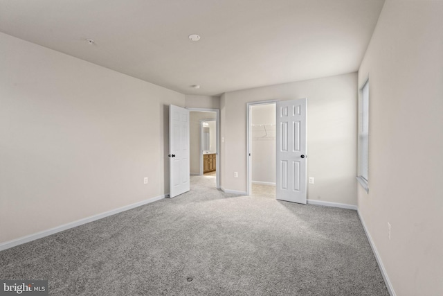 23348 Lindsay Dr, Leonardtown, MD 20650 - unfurnished bedroom with a closet, baseboards, light colored carpet, and a spacious closet