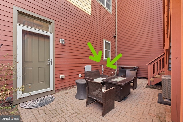 view of patio with a fire pit and central AC unit