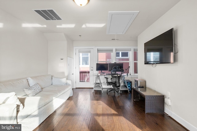 office area featuring baseboards, attic access, visible vents, and hardwood / wood-style floors