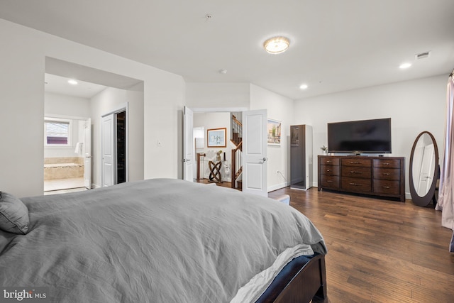 bedroom featuring recessed lighting, dark wood-style flooring, visible vents, baseboards, and ensuite bath