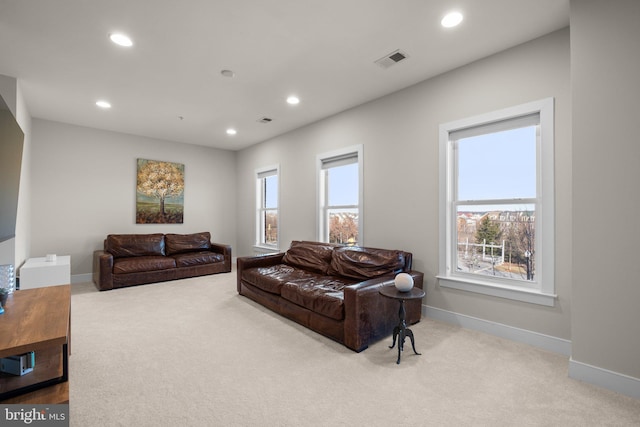 living area with carpet, visible vents, and recessed lighting