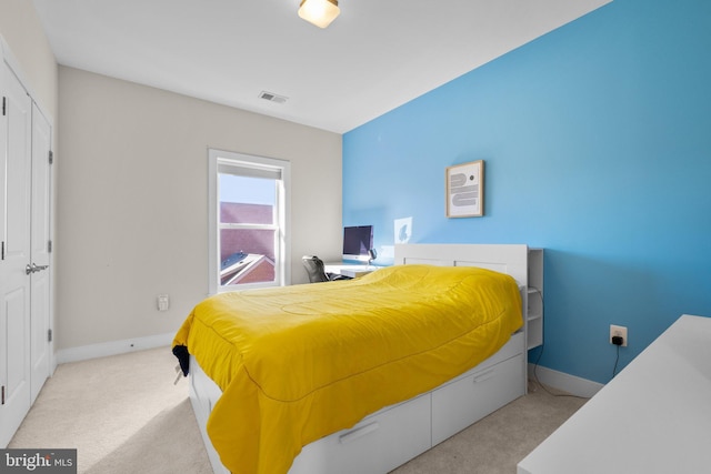 carpeted bedroom with visible vents and baseboards