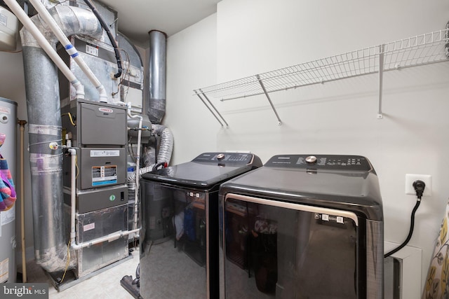 clothes washing area with tile patterned flooring, laundry area, and independent washer and dryer