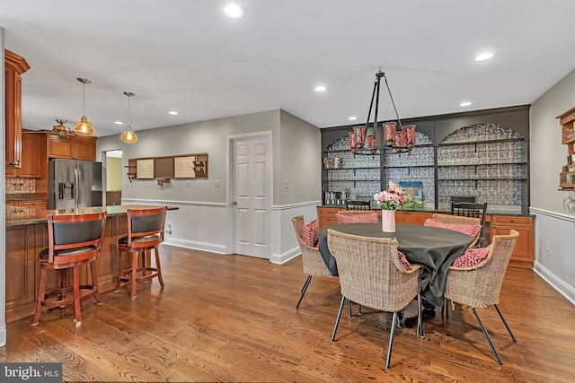 dining space with recessed lighting and wood finished floors