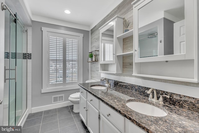 bathroom featuring toilet, tile patterned flooring, a sink, and visible vents