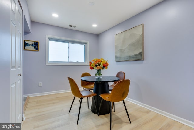 dining area with light hardwood / wood-style floors