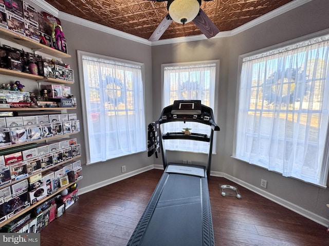 exercise room with an ornate ceiling, baseboards, dark wood-style flooring, and crown molding