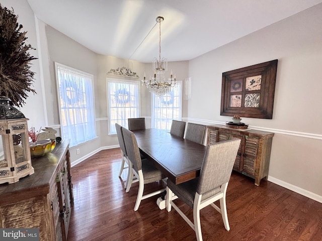 dining area with a notable chandelier, dark wood finished floors, and baseboards