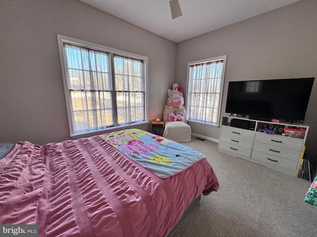 carpeted bedroom featuring a ceiling fan, lofted ceiling, and baseboards