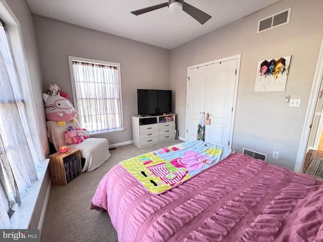 bedroom featuring light carpet, ceiling fan, visible vents, and baseboards