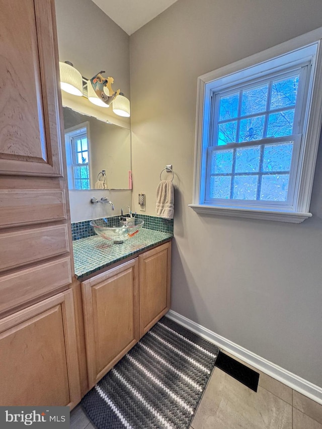 bathroom featuring vanity and baseboards