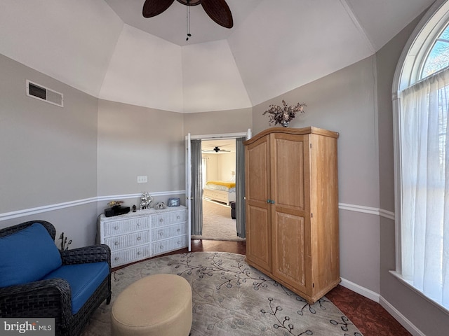 sitting room featuring lofted ceiling, ceiling fan, visible vents, and baseboards