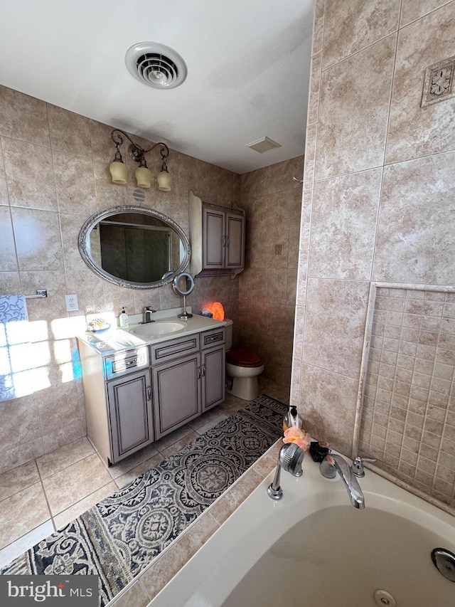 full bathroom featuring visible vents, a jetted tub, tile patterned flooring, vanity, and tile walls