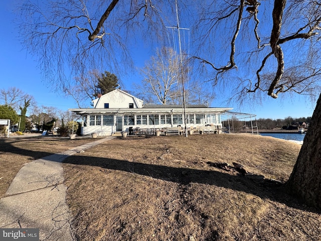 view of front of home featuring a chimney and a gambrel roof