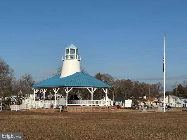 surrounding community featuring fence, a gazebo, and a lawn