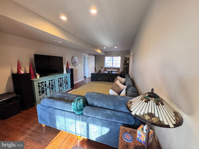 living room with dark wood-type flooring and recessed lighting