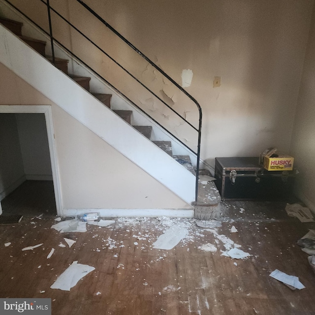 stairs with hardwood / wood-style flooring