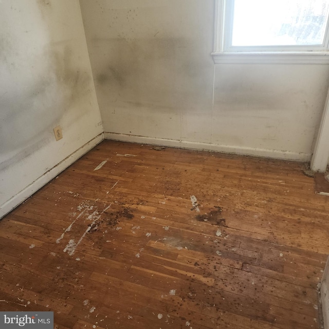 empty room featuring dark wood-type flooring