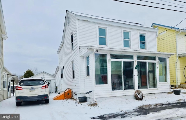 view of front of property featuring a sunroom