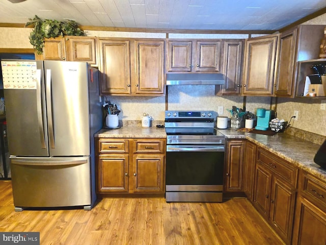 kitchen featuring appliances with stainless steel finishes and light hardwood / wood-style floors