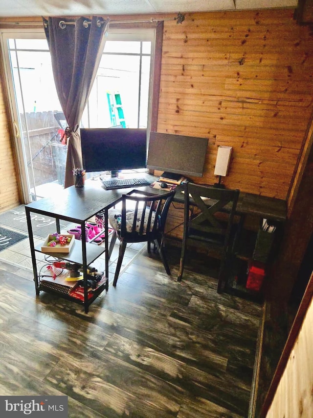 office area featuring dark hardwood / wood-style flooring and wooden walls