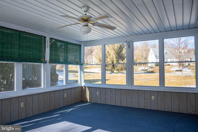 unfurnished sunroom with wooden ceiling and ceiling fan