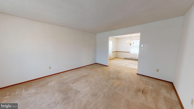 empty room with an inviting chandelier, a baseboard radiator, light carpet, and a textured ceiling