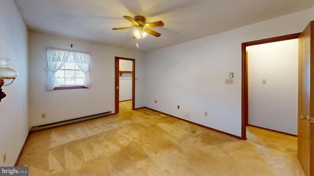 unfurnished room with baseboard heating, ceiling fan, and light carpet