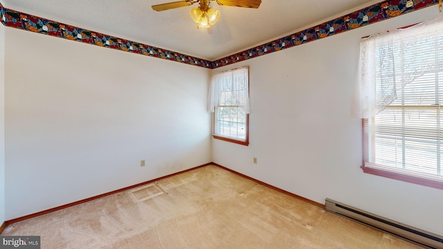 carpeted spare room with ceiling fan and baseboard heating