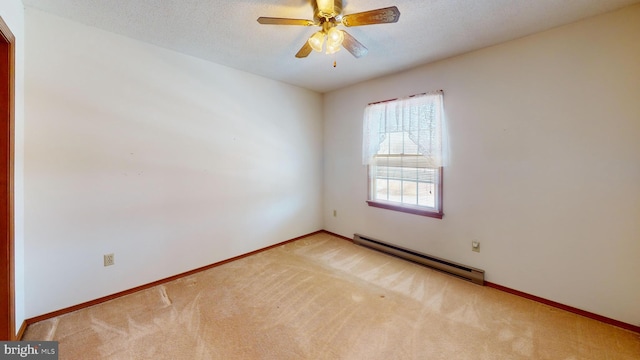 carpeted spare room featuring ceiling fan, a textured ceiling, and a baseboard heating unit