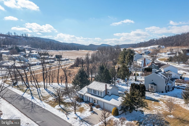 snowy aerial view featuring a mountain view