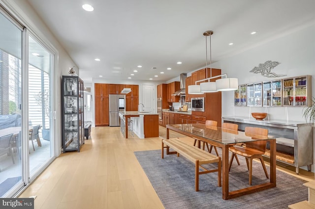 dining room with sink and light hardwood / wood-style floors